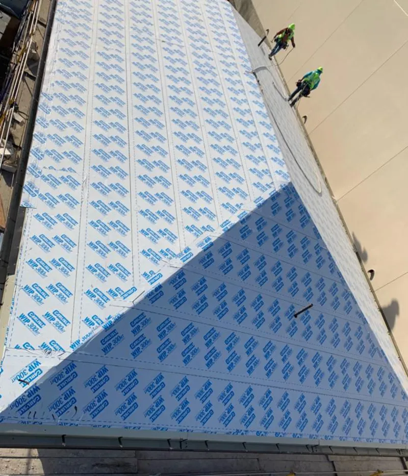 Professional roofers installing underlayment on a metal roof in Tamaqua